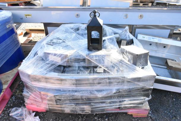 35 black wrought iron metal lanterns stacked and wrapped, one on top. Durable, ideal for decor. 35 times your bid.