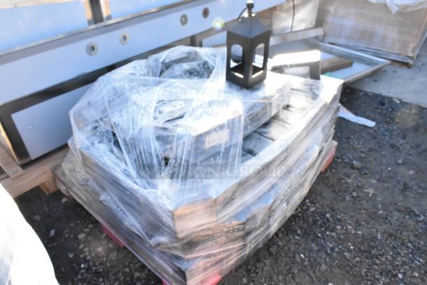35 black wrought iron lanterns on a pallet, wrapped in plastic; ideal for decorative purposes, minimal wear.