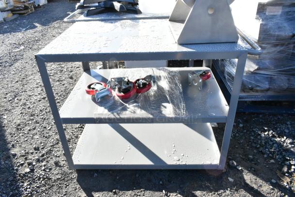 Brand new gray metal 3-tier cart with commercial casters, minor scratches, sturdy build, includes red casters.