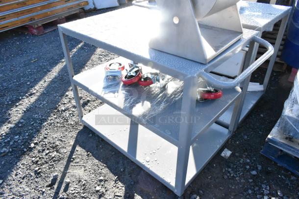 Gray metal 3-tier cart with commercial casters, brand new with minor scratches, shown with red caster wheels.