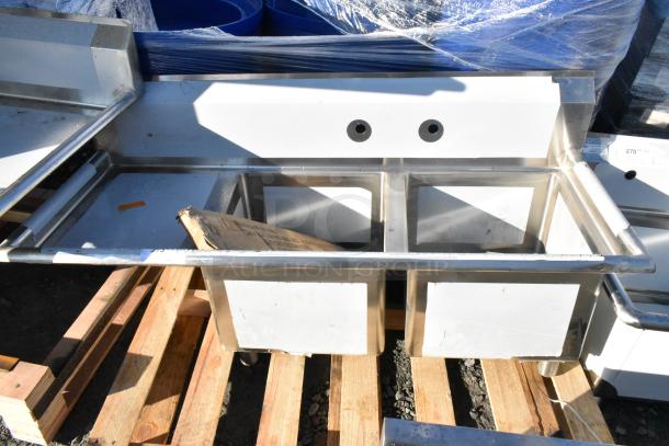 BRAND NEW SCRATCH AND DENT Regency 600S2171718L stainless steel 2 bay sink with left side drain board on wooden pallets.