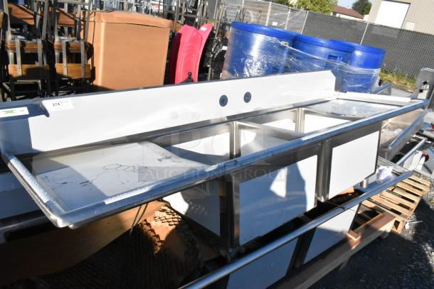 BRAND NEW Regency 600S22424224 stainless steel 2 bay sink with dual drain boards. Scratch and dent condition; tags visible.