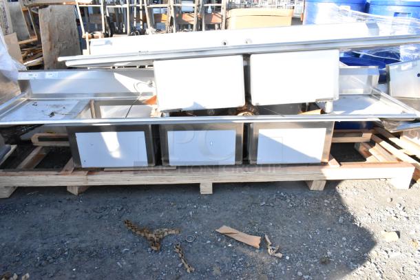 BRAND NEW SCRATCH AND DENT Regency 600S32424224 stainless steel 3 bay sink with dual drain boards, no legs, visible on pallet.