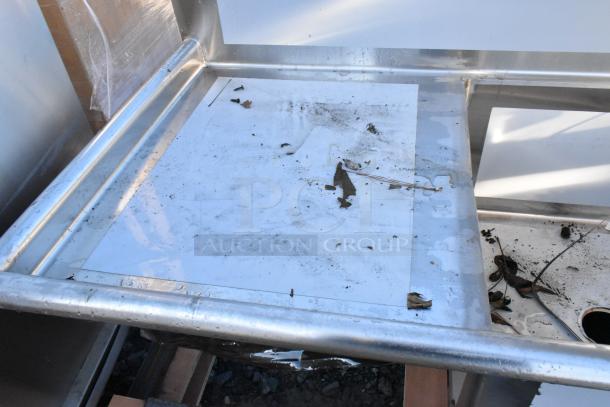 BRAND NEW SCRATCH AND DENT Regency 600S32424224 stainless steel 3 bay sink with dual drain boards, no legs, debris visible.