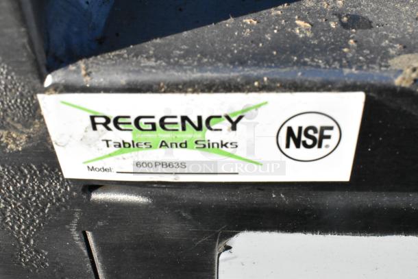 Regency 600PB63S stainless steel portable bar, scratch and dent, 63", with speed rails and ice bin, branded label visible.