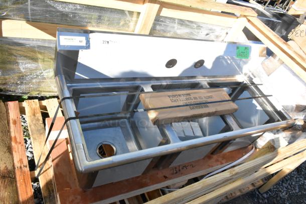 Brand new Regency 54" stainless steel three-compartment sink, 16-gauge, with galvanized steel legs, no drainboards. Scratch and dent condition.