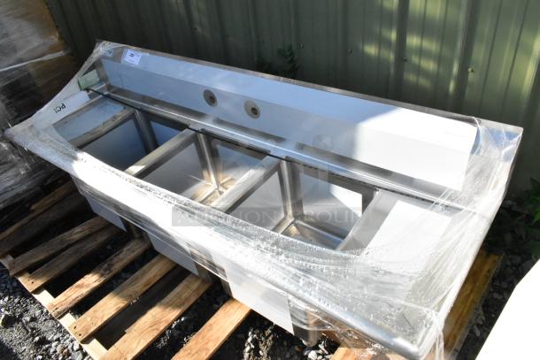 Brand new Regency 600S31416212 stainless steel 3-bay sink with dual drain boards, visible scratches and dents, no legs.