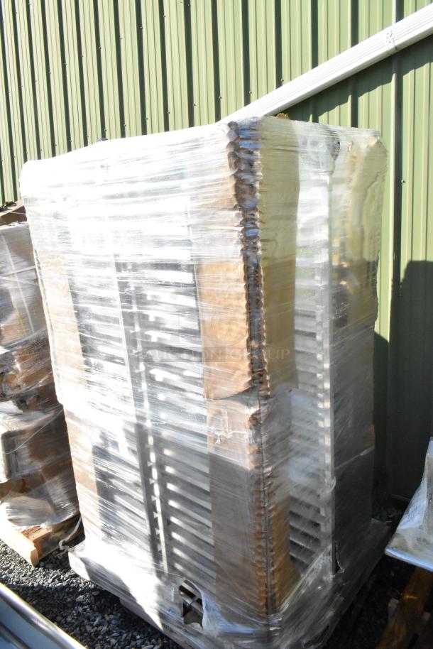 4 new Regency 20 Pan Aluminum Steam Table Pan Racks, assembled, wrapped in plastic, with minor scratches and dents.
