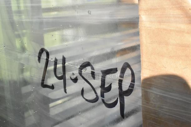 Packaged Regency 20 pan aluminum steam table rack, partially visible through wrap marked "24 SEP." Brand new, scratch and dent.