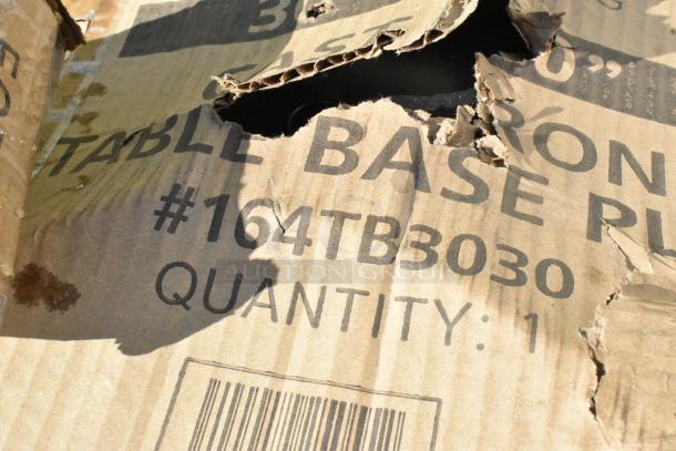 Torn cardboard with text "TABLE BASE PL" and "#164TB3030 QUANTITY: 1" visible. Package shows damage.