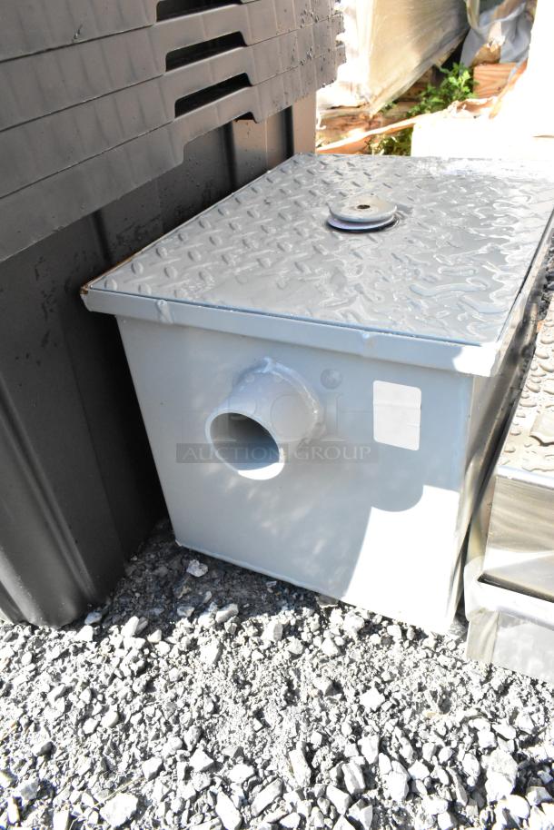 BRAND NEW Zurn Elkay GT2700-07-2NH grease trap, 7 GPM, 14 lb., 2" no-hub connections, minor dents visible, metal exterior.