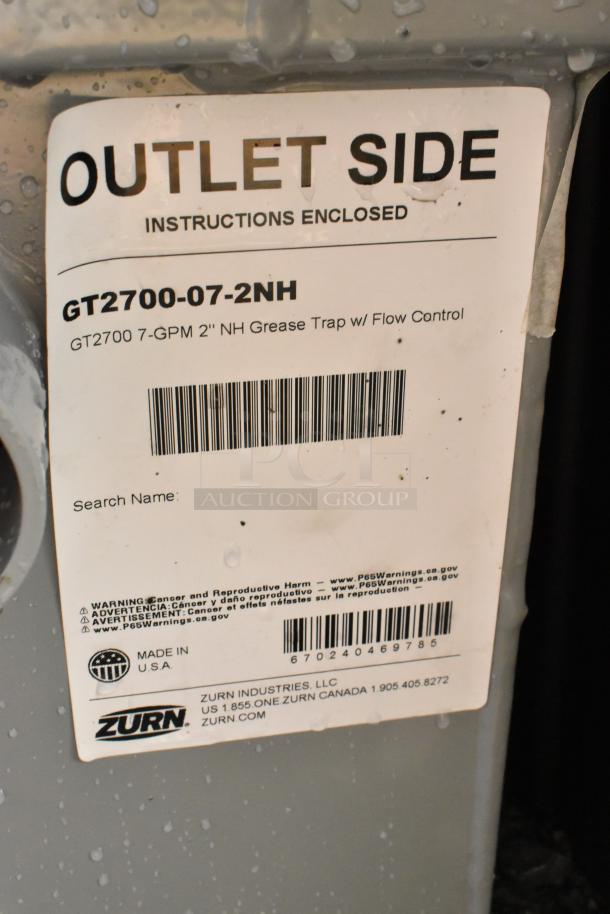 BRAND NEW Zurn Elkay GT2700-07-2NH grease trap, 14 lb., 7 GPM, with 2" no-hub connections, label shows "Outlet Side."