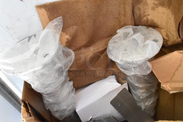 BRAND NEW SCRATCH AND DENT Regency 600HSMSB1872 wall-mounted hand sink parts in packaging.