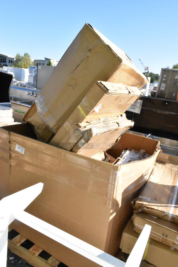 Cardboard boxes labeled "7 Brand New Scratch and Dent" containing tabletops and wire rack, showing external wear.