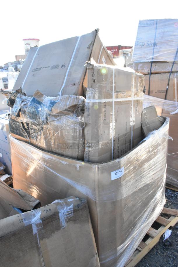 Pallet with 8 brand new scratch-and-dent items in boxes, including a shelf and liquor display rack. Boxes are sealed and labeled.