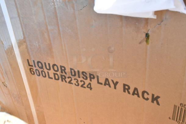 Cardboard box labeled "Liquor Display Rack 600LDR2324," part of 8 scratch-and-dent items, includes shelf.