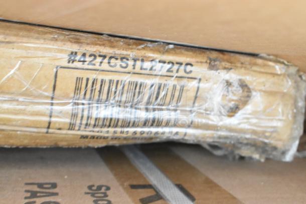 Cardboard packaging with label "#427CSTL2727C", indicating brand new scratch and dent items, including shelf and liquor display rack.