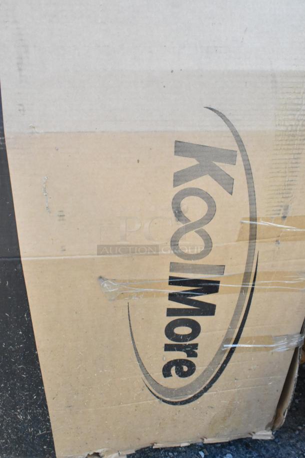 KoolMore KM-VMNT-50-BR non-refrigerated vending machine box with visible logo, showing scratches and dents. 