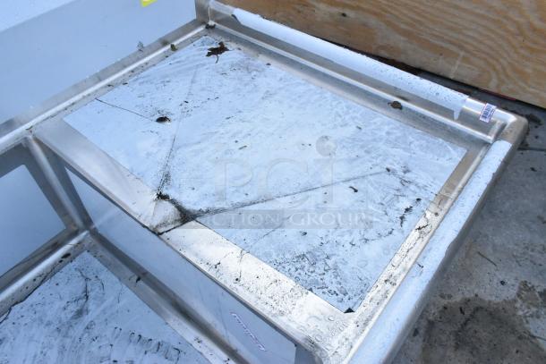 Brand new Regency 600S32030224 stainless steel 3 bay sink, dual drain board, visible scratches and dents, auction item.