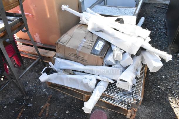 Lot of various items including chrome wire shelves and metal pieces. Items are brand new but have scratch and dent marks.