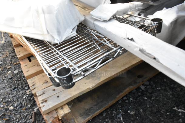 Lot of chrome finish wire shelves and metal pieces on a pallet. New condition with packaging, minor scratches visible.