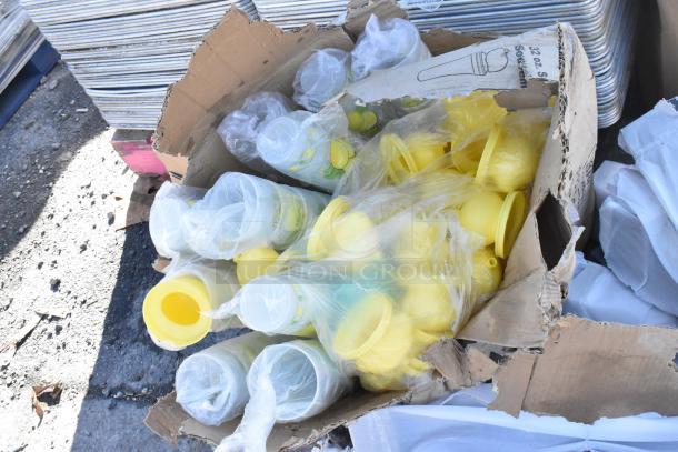 Damaged box containing yellow plastic items, possibly cups or containers, wrapped in plastic. Box appears worn.