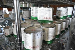 30 Pro Guard Chemicals, including 1501 Proflex Primer Part A. New, sealed cans on metal shelf, diverse chemical products.