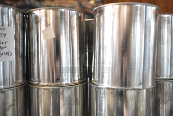 49 metal cans of Pro Guard Chemicals, with labels indicating batch quantity, auctioned in bulk.