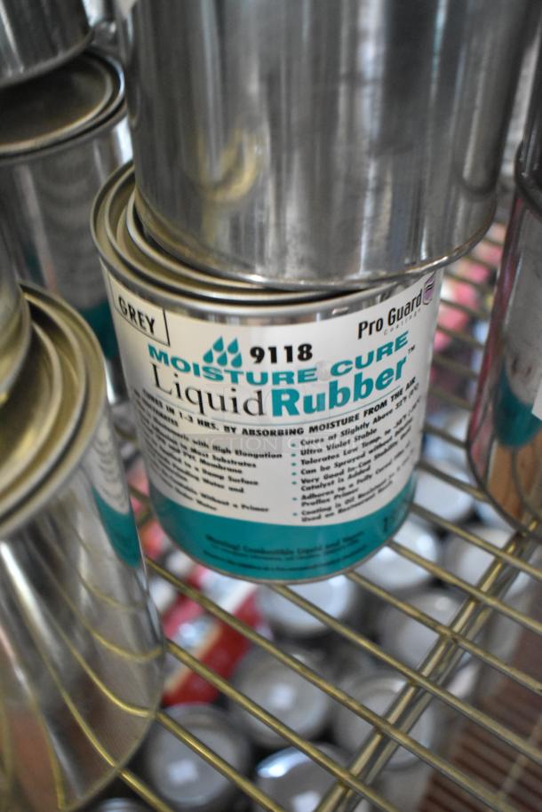Cans of Pro Guard Moisture Cure Liquid Rubber on a shelf, labeled as liquid roof sealant, offering moisture protection.