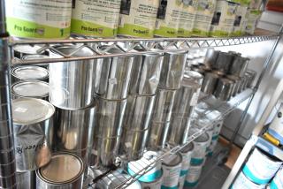 107 Pro Guard Chemical cans, various types and sizes, displayed on metal shelves. Some cans labeled and marked "Gray."