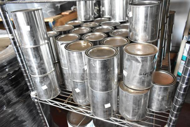 107 Pro Guard chemical cans, including gray variants, stacked on metal shelving, ready for auction.