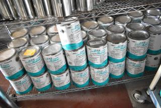 55 cans of Pro Guard 9118 Moisture Cure Liquid Rubber on metal shelving. Labels show product details and grey color.