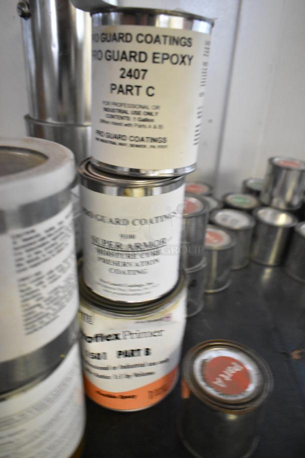 38 cans of Pro Guard Coatings, including Epoxy Clear Primer Part A, 2524 Milliken Blue Primer, 2407 Part C Epoxy.