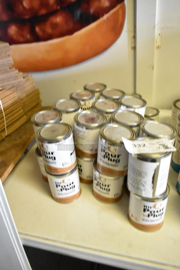 35 cans of Pro Guard Chemicals, including 9111 Pour N Plug, stacked on a table. Labels detail product type and instructions.