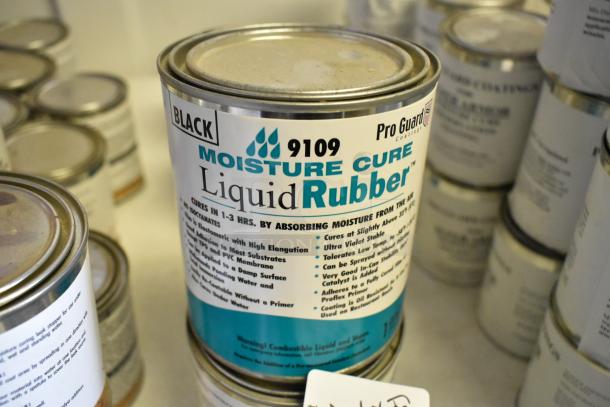 Pro Guard 9109 Black Moisture Cure Liquid Rubber can, part of a lot of 5 various Pro Guard chemicals, shown in focus.