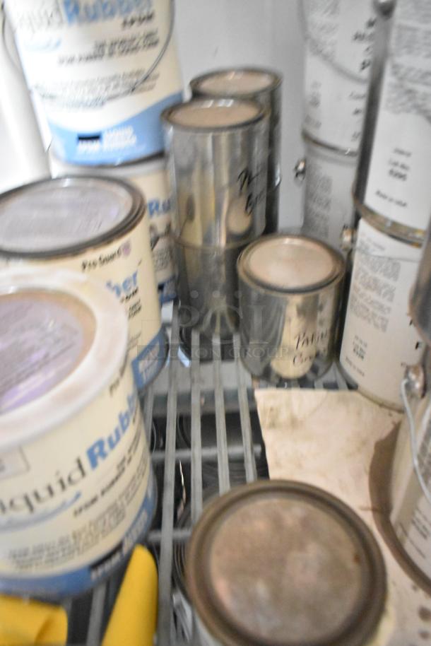 Cans of Pro Guard chemicals, including MC Poly Restoration Coating Part B and Liquid Rubber Patina Green, on a shelf.