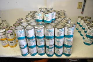 131 cans of Pro Guard 9118 Moisture Cure Liquid Rubber, neatly stacked, showcasing labels with product details.