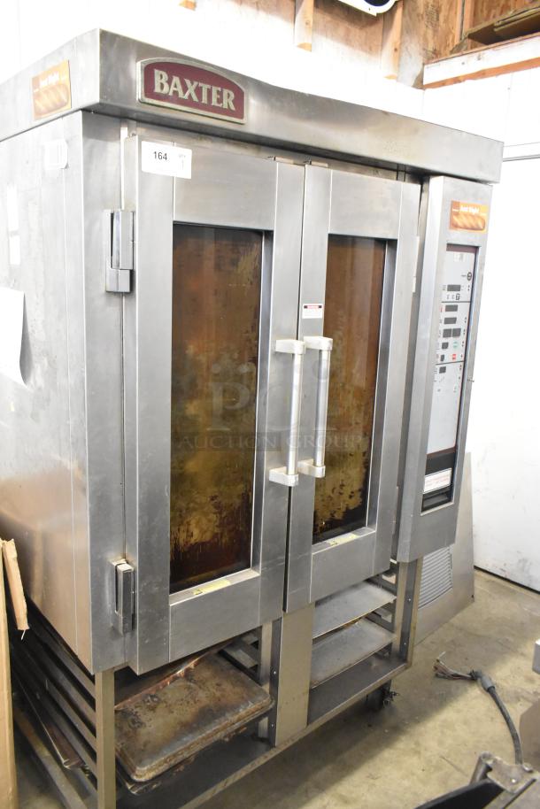 Baxter stainless steel commercial electric mini rotating rack oven, features dual pan racks, casters; visible wear.