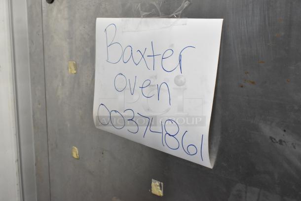 Baxter stainless steel commercial oven with electric power and mini rotating rack. Features dual pan rack and casters. Note reads "Baxter oven 00374861."