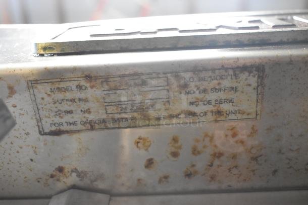 Baxter stainless steel commercial electric mini rotating rack oven with dual pan rack and casters, showing worn data label.