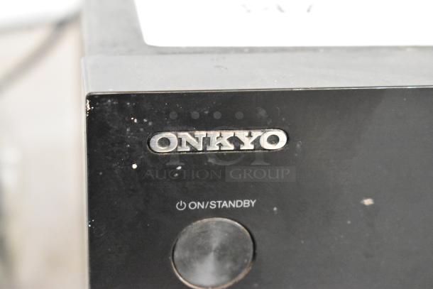 Onkyo TX-SR373 AV Receiver, black, visible On/Standby button, some surface wear, distinctive Onkyo logo.