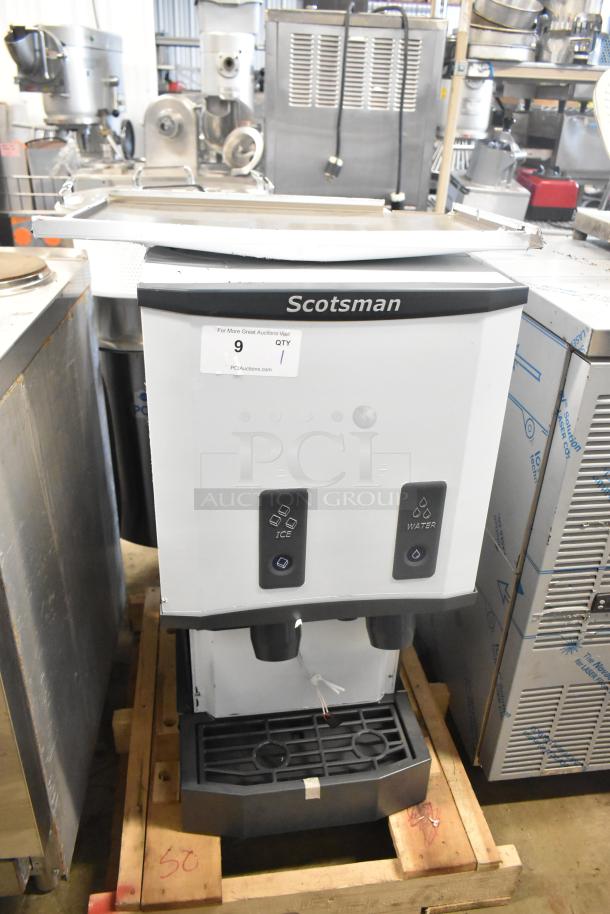 Brand new Scotsman HID312AB-1A stainless steel ice and water dispenser, 12 lb. bin, push button, 115V, displayed on wooden pallet.