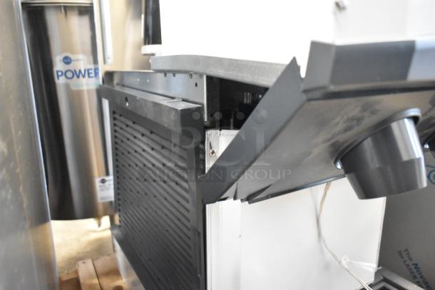 Brand new Scotsman HID312AB-1A Meridian stainless steel countertop ice machine with 12 lb storage, minor dents visible.