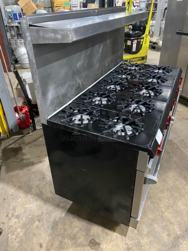 Vulcan commercial 10 burner range with double oven, stainless steel, natural gas, overhead salamander shelf, on casters.