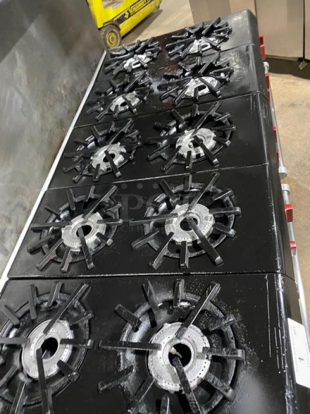Vulcan commercial stainless steel 10-burner range and double oven combo with gas power, backsplash, salamander shelf, wired oven rack, and casters.