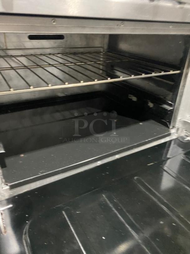 Vulcan stainless steel oven interior with wired rack, part of a commercial 10 burner range/oven combo.