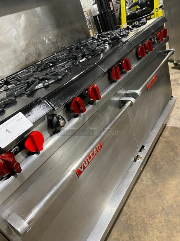 Vulcan commercial stainless steel 10-burner range with double oven, overhead salamander shelf, and backsplash on casters.