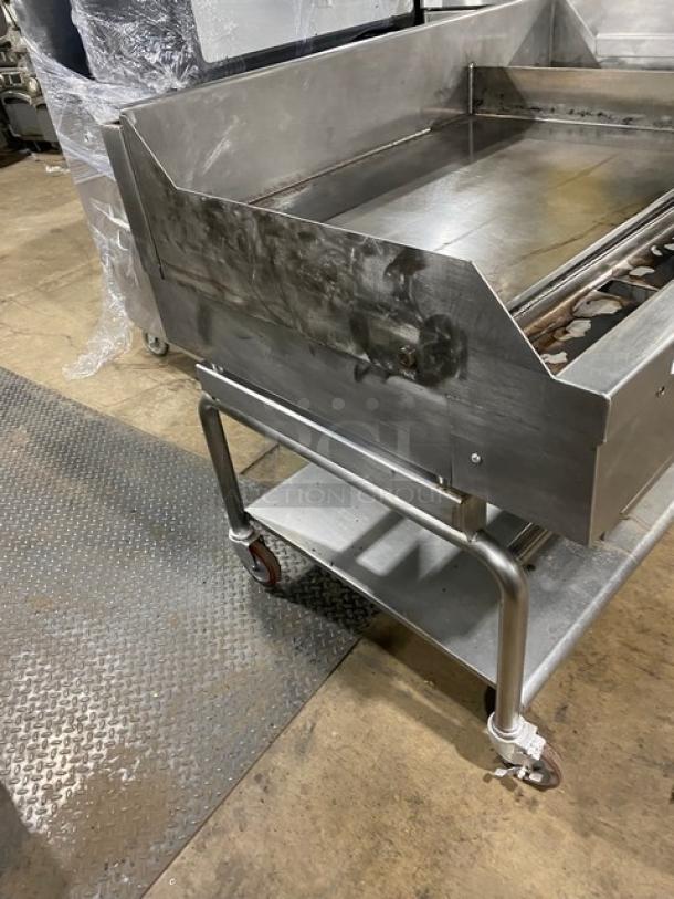 WoodStone stainless steel natural gas plancha griddle on casters with back and side splash, single undershelf cart, SN: GP1B16MAY1704992.