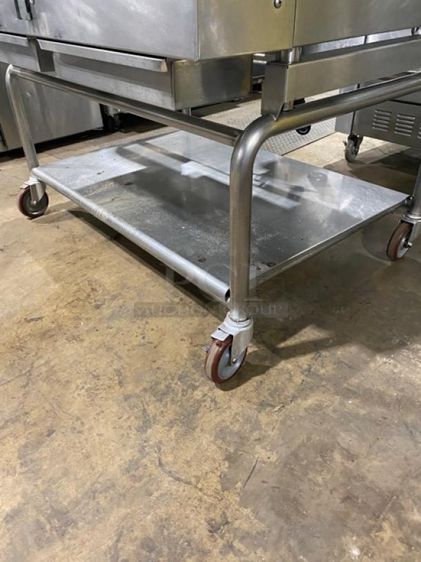 WoodStone stainless steel natural gas countertop plancha flat griddle with back and side splash, on a single undershelf cart with casters.
