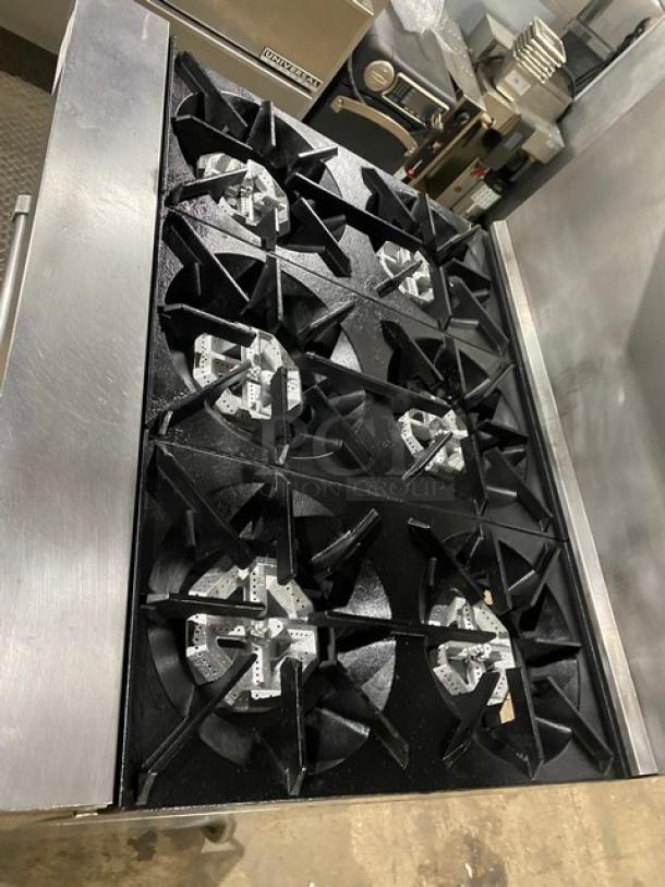Garland SunFire Series stainless steel 6-burner range/oven combo, model SX-6-26, with U.S. Range salamander broiler, on casters.